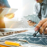 A person works at a computer on project management.