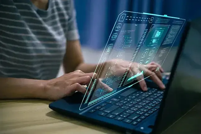 A person engaged with a laptop displaying a sleek, futuristic interface, showcasing advanced technology and design.
