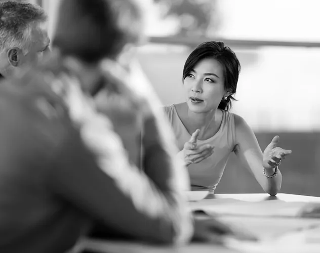 A woman discussing with a man during a meeting.