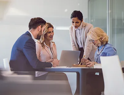 A diverse group of business professionals collaborating in a modern office setting.
